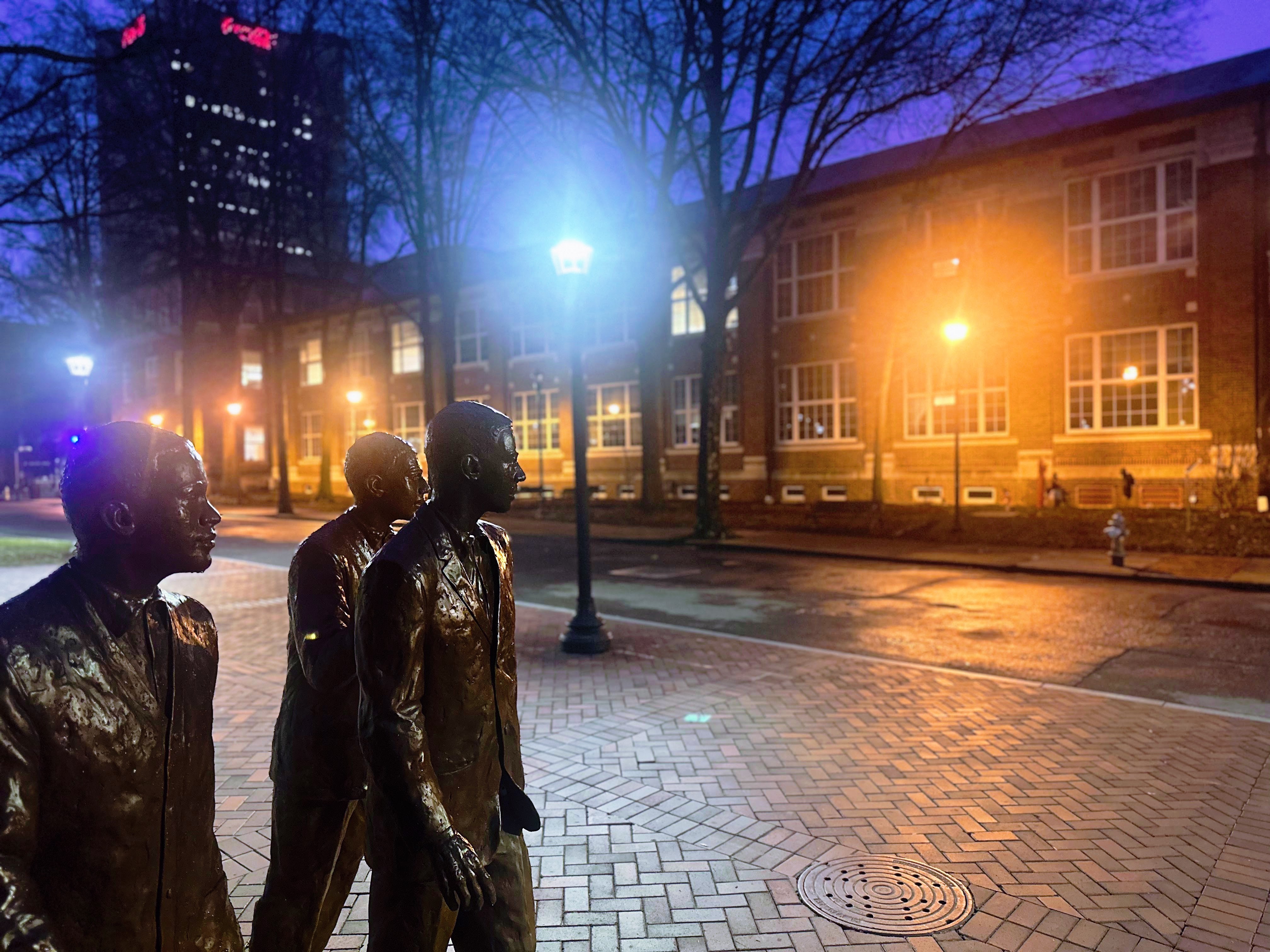 Three Pioneers at the Harrison Square. JS Coon building, the home of PBS in the background.  Image credit: PBS Stock Image.