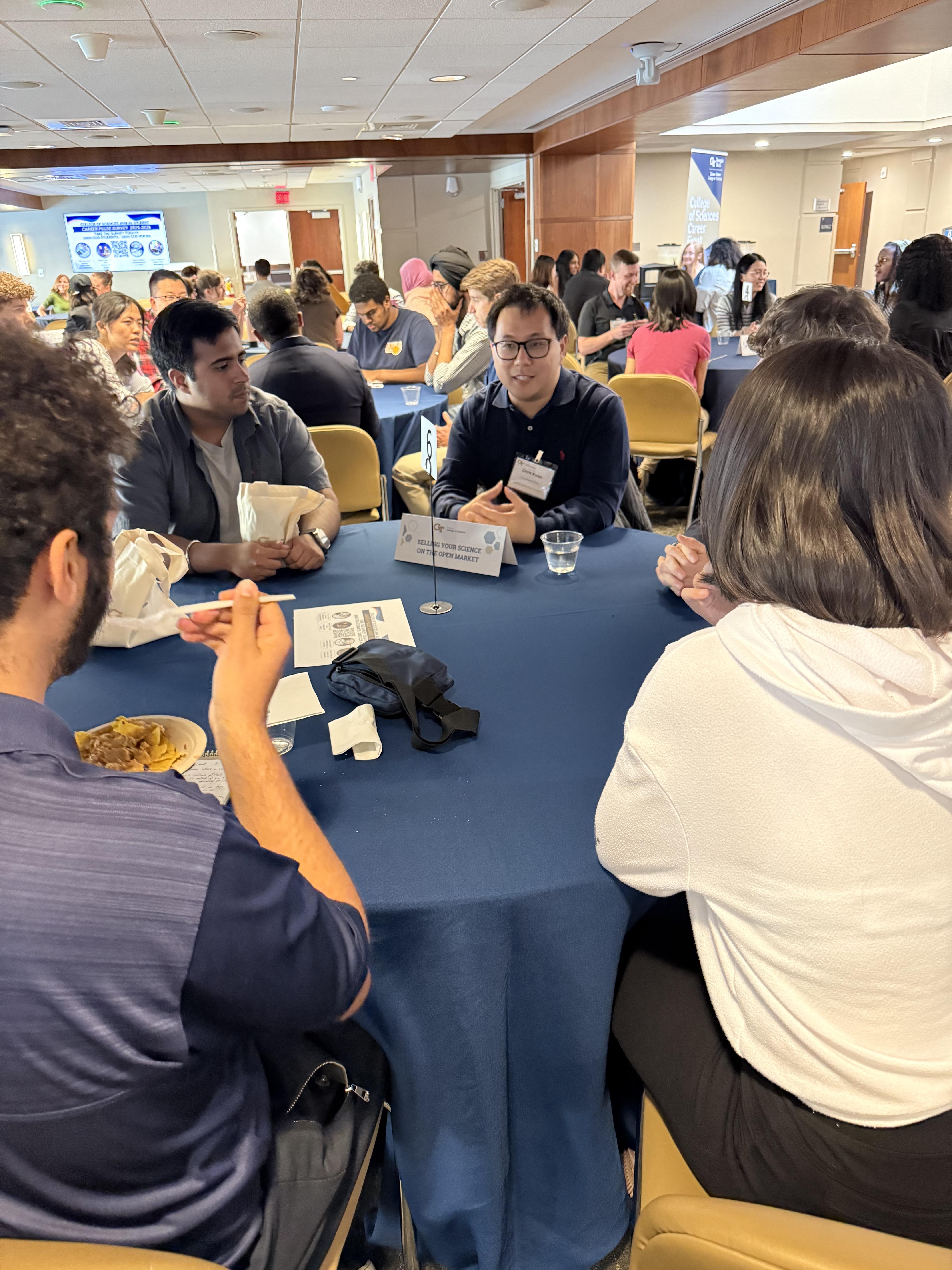 A group sits around a round table