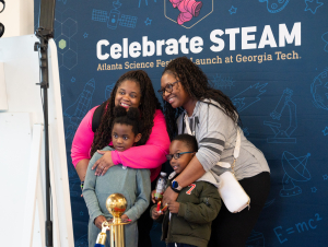 A family poses for a special moment in the Celebrate STEAM photo booth during Georgia Tech's Celebrate STEAM event on March 8.