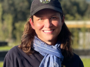 Headshot of a woman wearing a Dian Fossey gorilla fund ball cap